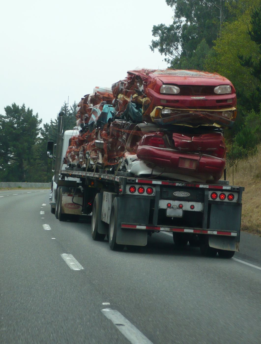 Crushed cars loaded for transport